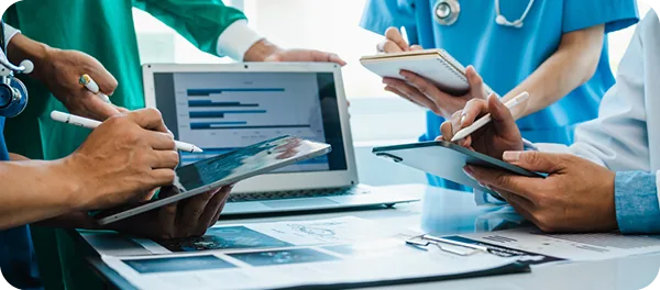 Healthcare professionals reviewing patient information on tablets