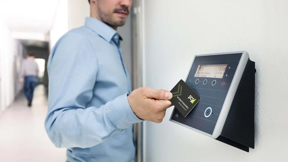 Employee entering a building with an RFID card reader