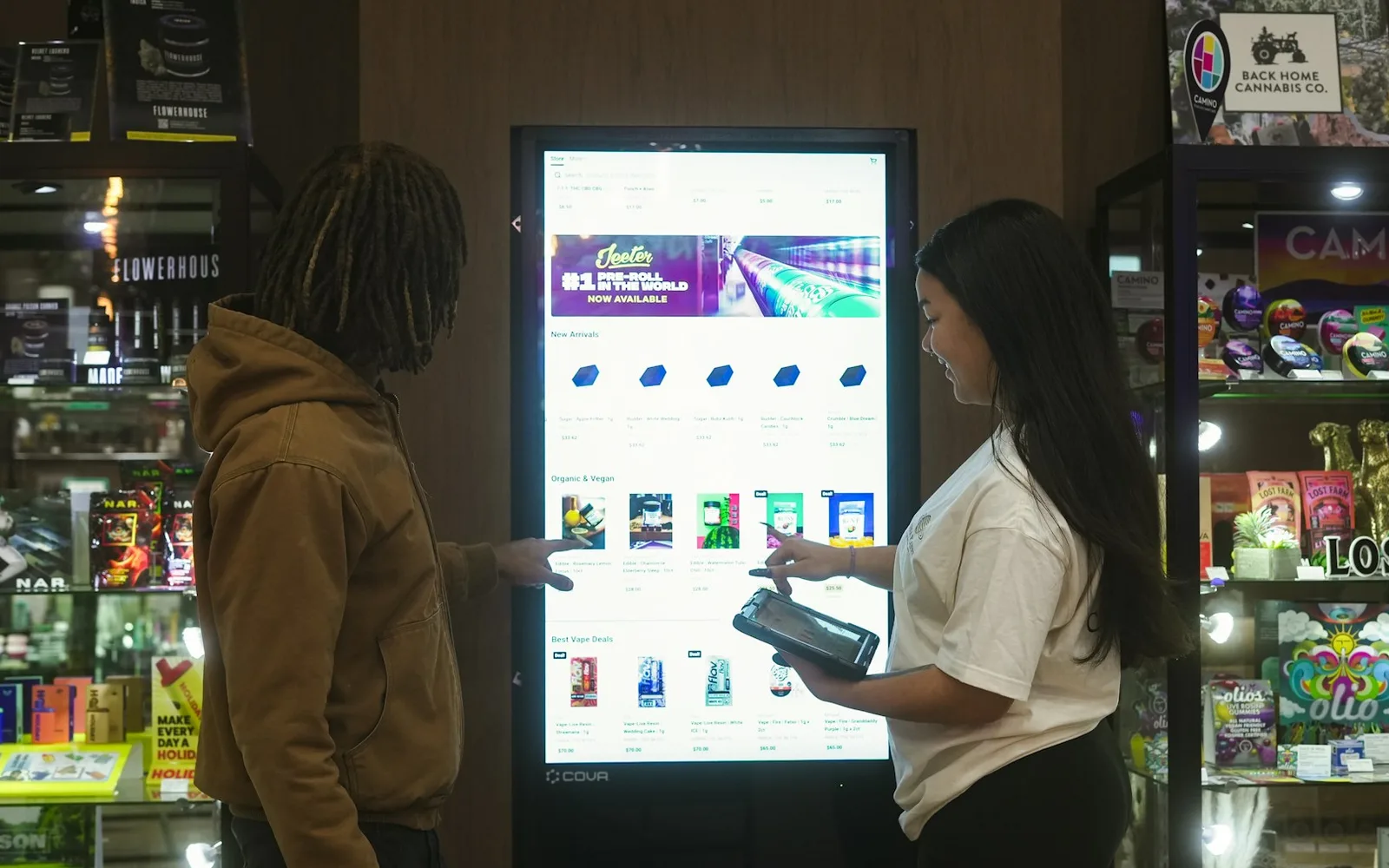 Shoppers using an interactive digital signage kiosk in a store